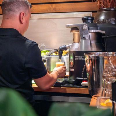 A person preparing fresh-squeezed juice.