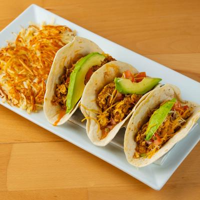 Chorizo tacos, with scrambled eggs, tomato, cheese, and avocado.