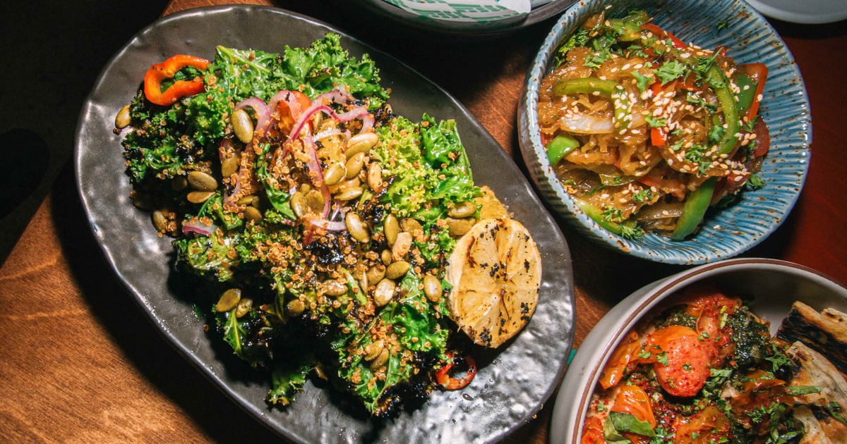 A colorful, healthy spread featuring grilled kale salad and noodles