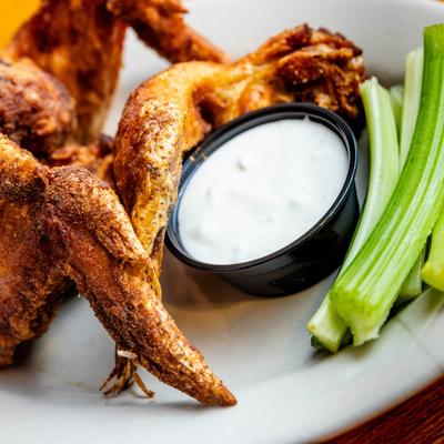 Signature jumbo whole wings with celery and ranch dressing.
