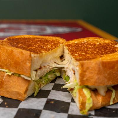 Chicken sandwich, with provolone, lettuce and tomato.