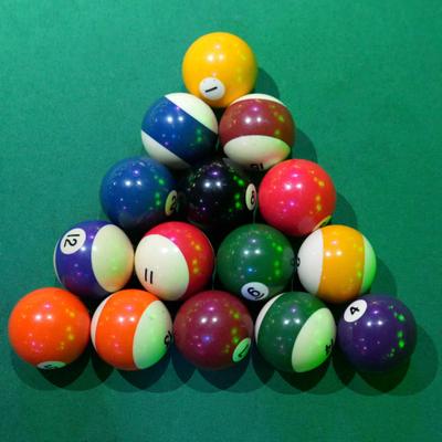 Set of billiard pool balls arranged in a triangle rack.
