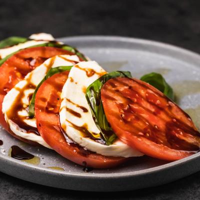 Caprese salad with tomatoes, mozzarella, basil and balsamic glaze.