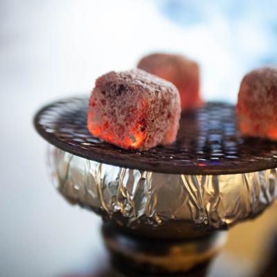 Coconut charcoal cubes on a hookah bowl.