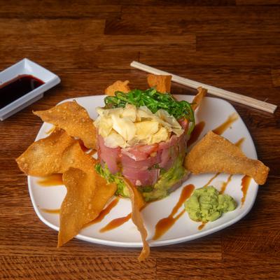 Tuna poke stack served alongside crispy fried wonton chips.
