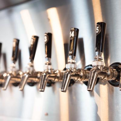 Several beer taps mounted on a wall.