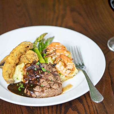 Grilled Filet Mignon & Marinated Shrimp with mashed potatoes, roasted asparagus and portabella fries