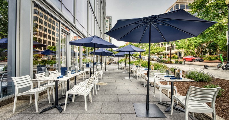 Exterior seating area with chairs, tables and parasols