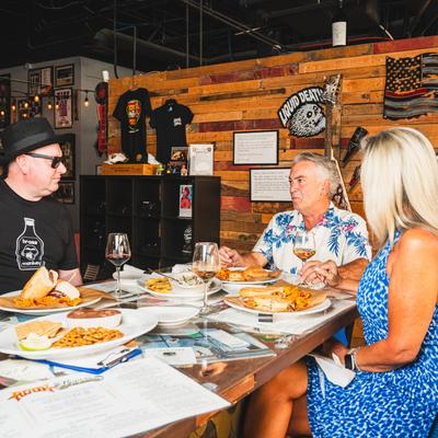 A group of seated guests talking over a meal.