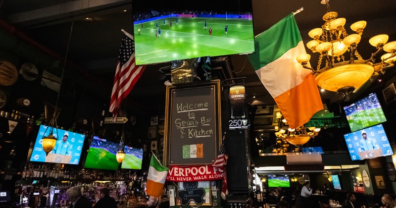 Flags and TV screens showing a soccer game
