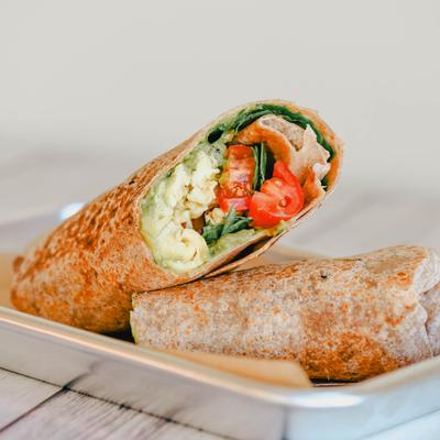 Wrap with smashed avocado, scrambled eggs, balsamic, greens, and tomatoes.