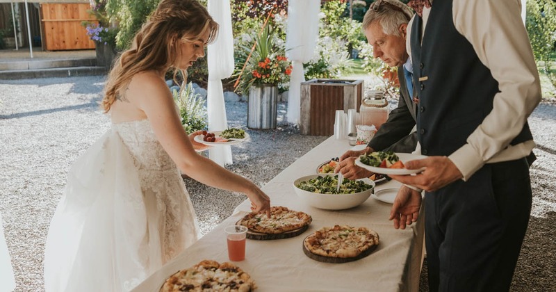 People serving themselves at the wedding buffet