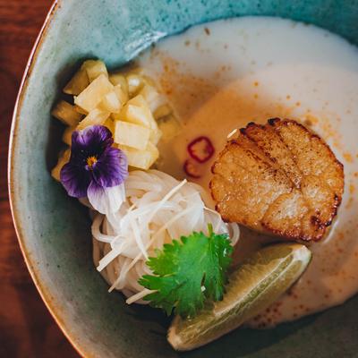 Grilled scallops, coconut curry noodles, ginger, dry shrimp, and pineapple.