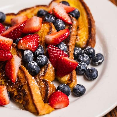 French toast topped with strawberries and blueberries.