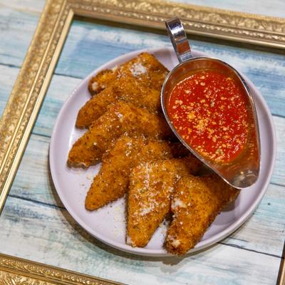 Fried mozzarella sticks served with marinara sauce.