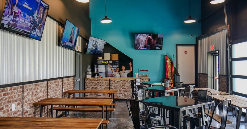 Interior space, seating area and bar, TV sets on the wall