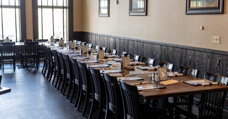 Interior, dining area, long table setup, wooden tables and chairs, ready for guests