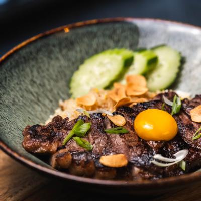 Beef Steak with Tallow Fried Rice topped with egg yolk.