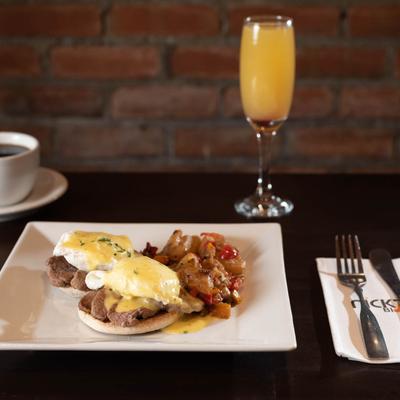 Eggs Benedict with orange juice and coffee.