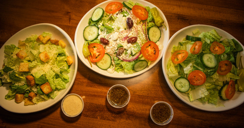 Different types of fresh salad displayed