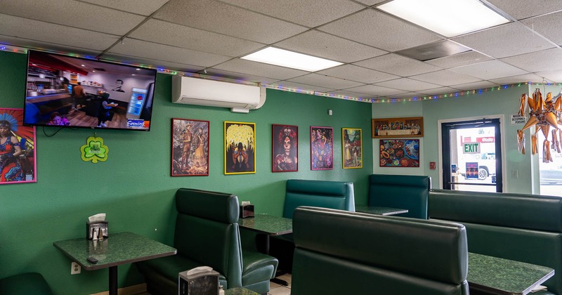 Interior, dining booths near wall with pictures