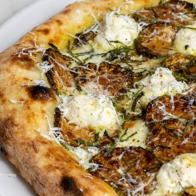 Zucchini and ricotta pizza, closeup.