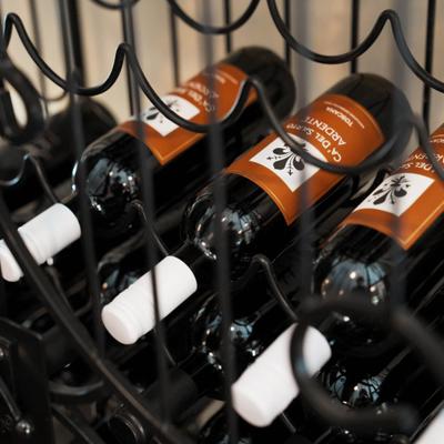 Wine bottles on a metal rack.