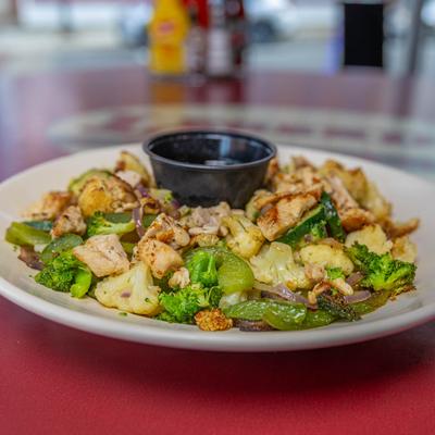 Chicken Stir - Fry with a cup of sauce.