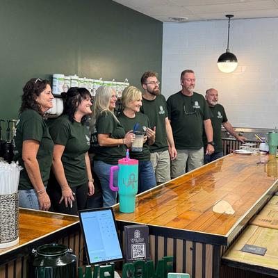 Staff posing for a photo behind the bar.