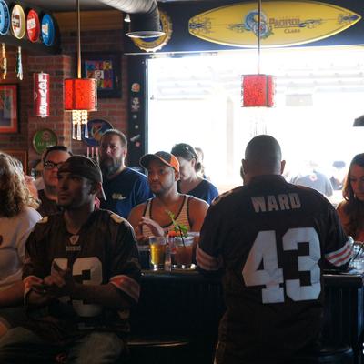 People watching the game, guy in a ward 43 jersey