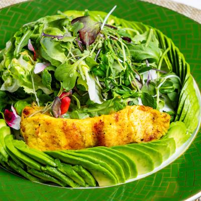 Bangkok salad with mixed greens, avocado, chicken, and peanut dressing.