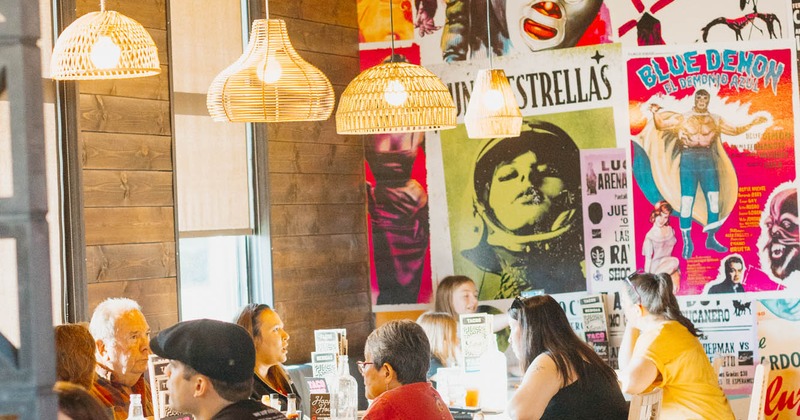 Diner area, tables and chairs, guests, chandelier