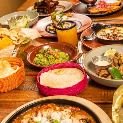 An assortment of dishes and drinks placed on a table side by side.