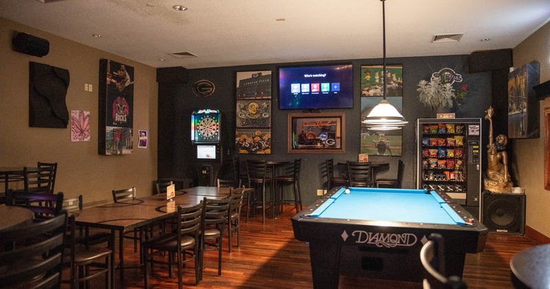 Interior, party room, tables and chairs, pool table, electronic darts, vending machine
