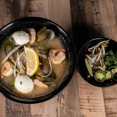 Seafood Ramen served with a side dish of bean sprouts, cilantro and jalapenos.