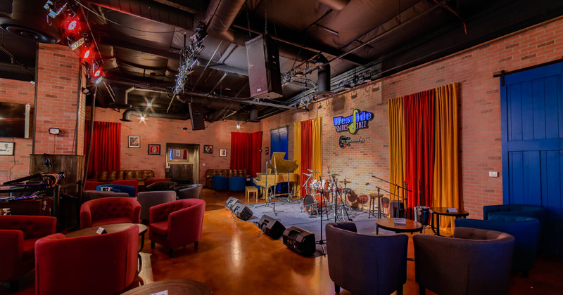 Interior, seating area around a stage with musical instruments