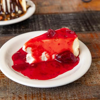 Piece of Strawberry Cheesecake served on the plate.