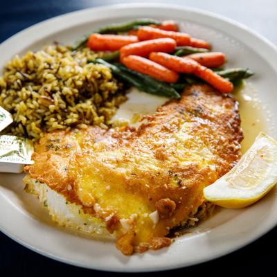 Whitefish Francaise with seasoned rice, glazed carrots, and green beans.