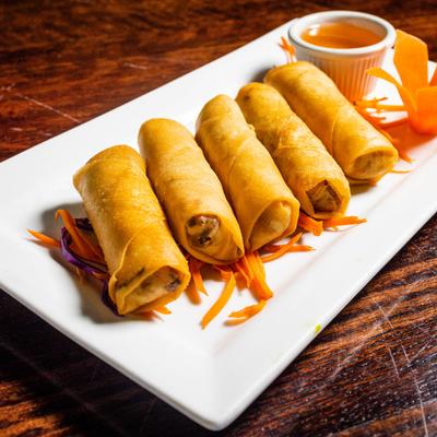 Five crispy Spring Roll on plate with sauce on side