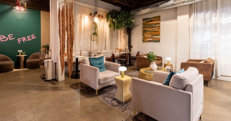 Interior, stylish lounge with modern decor, gray chairs, green accent wall, plants decoration