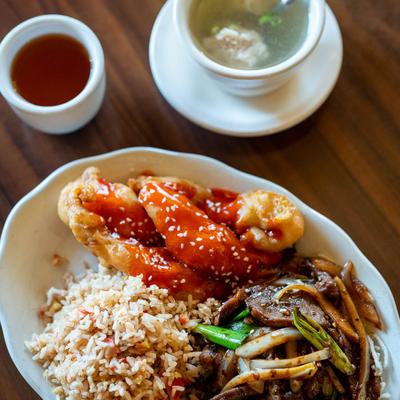 Sweet & Sour Chicken & Mongolian Beef Lunch Special serve don a table.