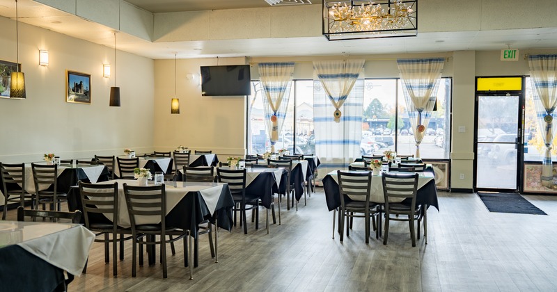 Wide view to restaurant interior, diner tables and chairs