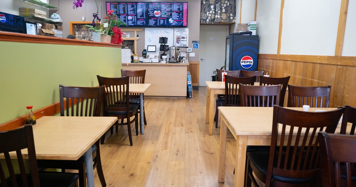 Interior, dining area, tables for two and four, ready for guests, checkout counter in the back