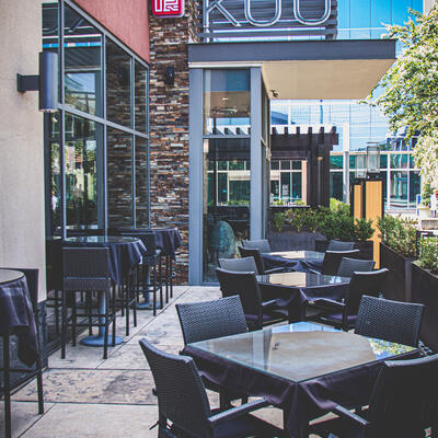 Restaurant exterior, tables for four ready for guests