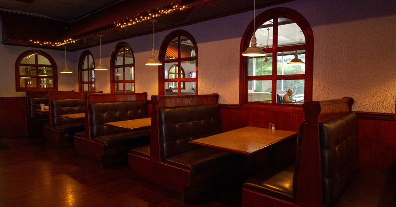 Interior, wooden seating booths with leather padded seating, soft lighting