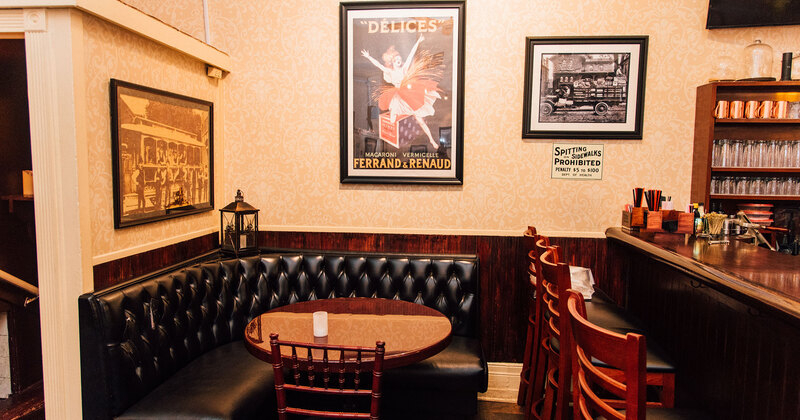 Interior, Table by the bar and the wall decorated with pictures
