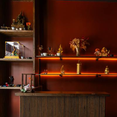 Interior decor, shelves adorned with statues, figurines, and orange LED lighting.