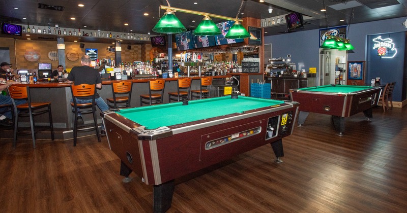 Interior, bar area, pool table, bar behind, bar stools