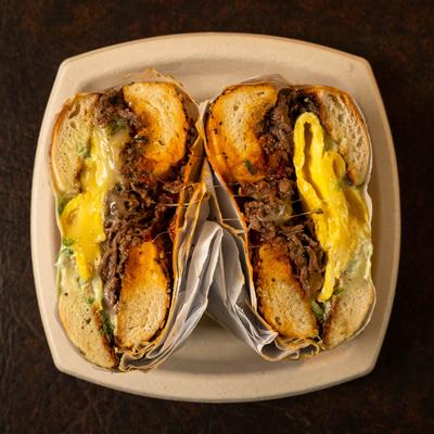 The Roast  sandwich plate sits on a dark textured surface.