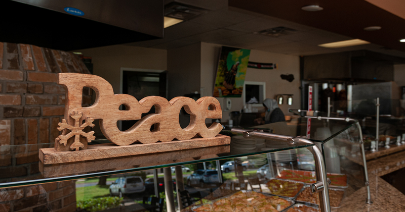 Wooden peace sign above buffet table